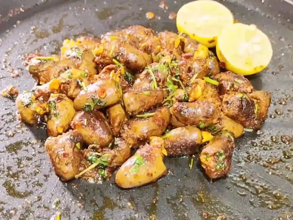 Crispy fried chicken hearts served on a plate with dipping sauce