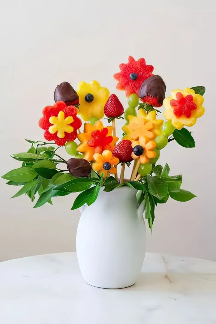 A vibrant fruit bouquet featuring a variety of fresh fruits arranged like flowers.