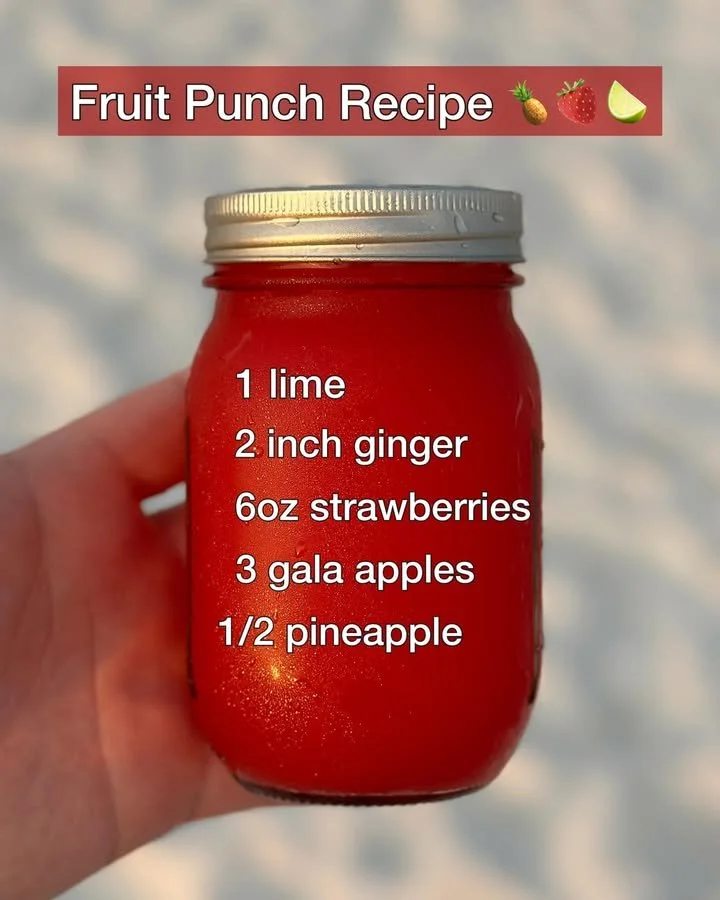 Colorful fruit punch beverage in a glass with assorted fruits
