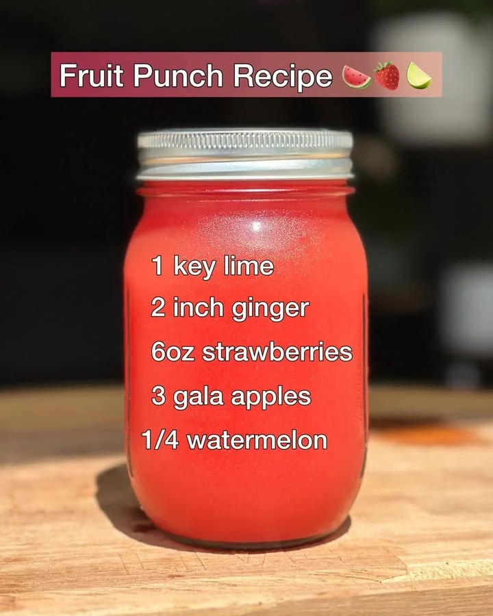 Refreshing fruit punch in a glass surrounded by fresh fruits.