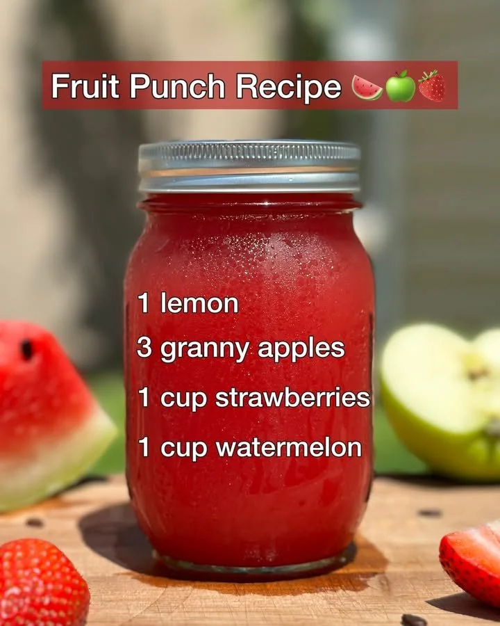 Colorful Fruit Punch in a glass with fresh fruit garnishes