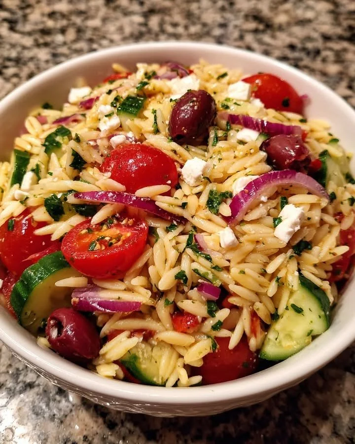 Greek Orzo Salad served with lemon dressing and fresh vegetables