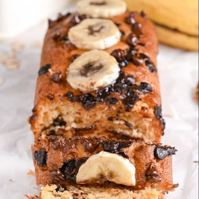 Slice of Greek Yogurt Banana Bread on a plate with bananas