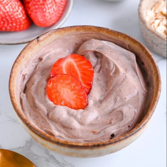 Delicious Greek yogurt protein mix in a bowl with fresh fruits and nuts.
