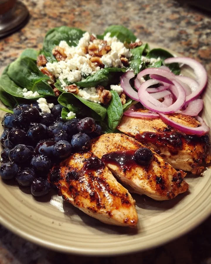 Grilled chicken topped with blueberry balsamic glaze and spinach walnut salad with feta.
