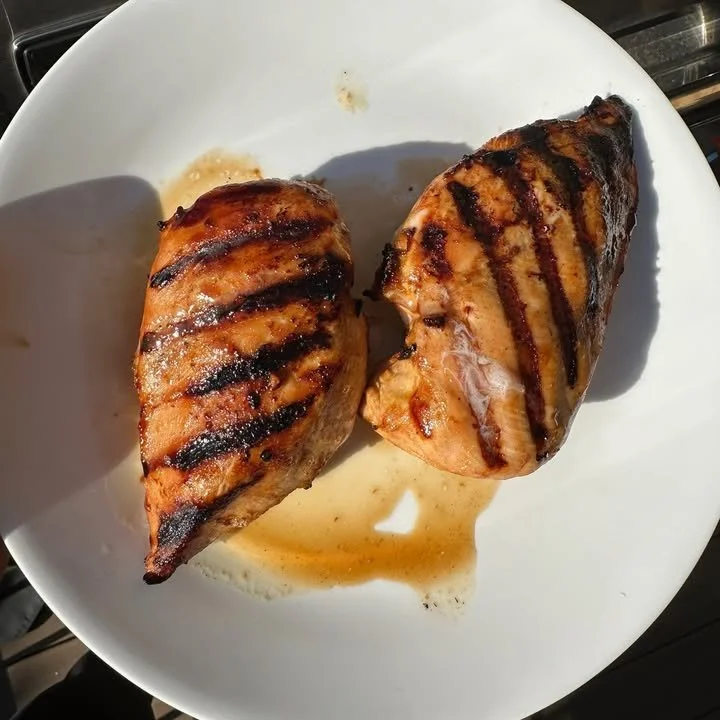 Juicy grilled chicken marinated in flavorful herbs and spices on a barbecue grill