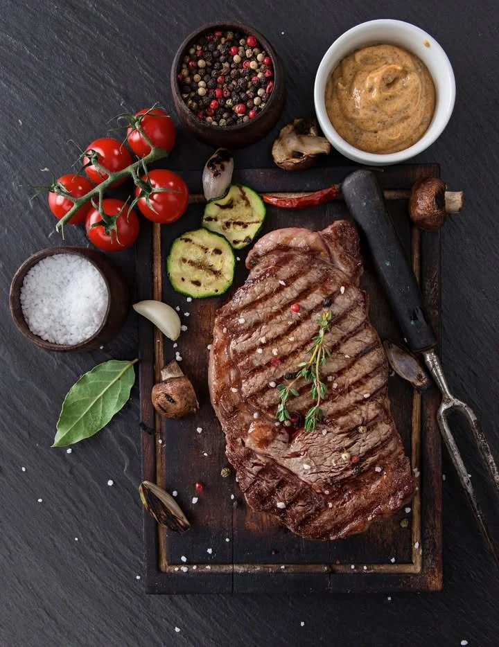 Delicious grilled ribeye steak with grilled vegetables and pepper sauce
