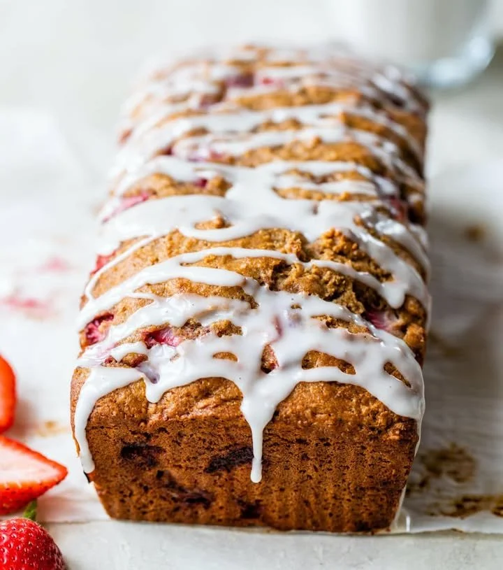Healthy strawberry bread freshly baked and sliced on a wooden table