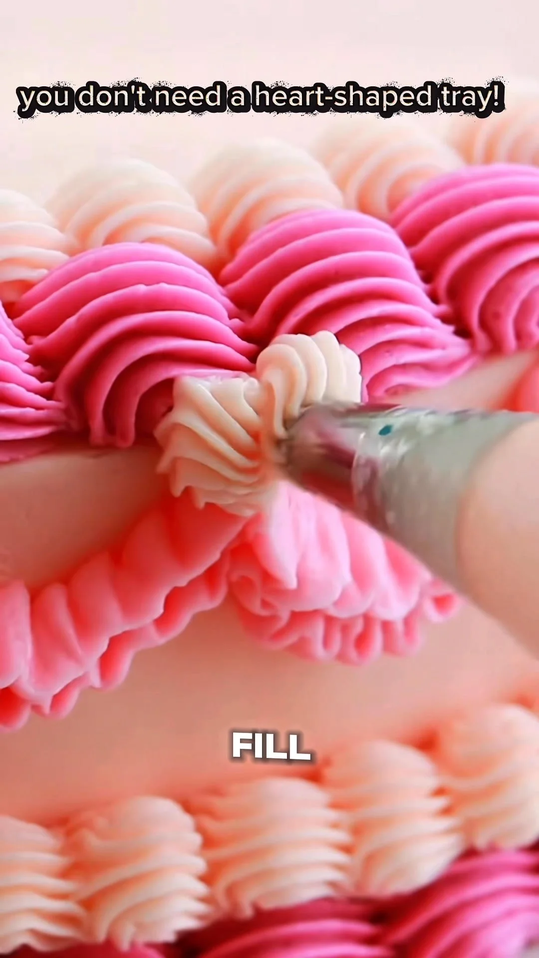 Delicious heart-shaped cake decorated with frosting and sprinkles