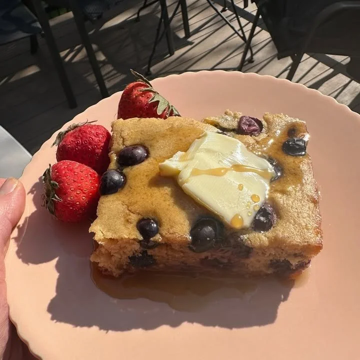 High-protein blueberry pancake breakfast cake topped with fresh blueberries