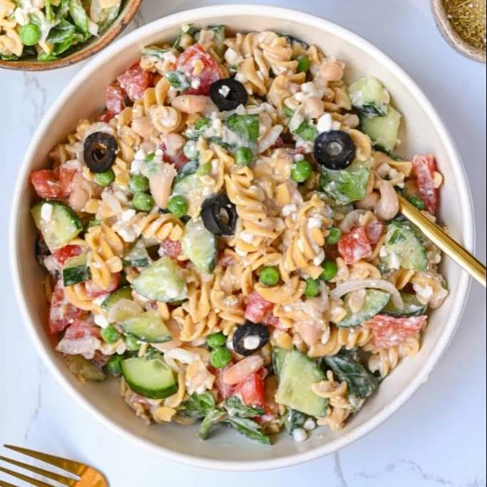 Delicious high protein pasta salad with colorful vegetables and dressing
