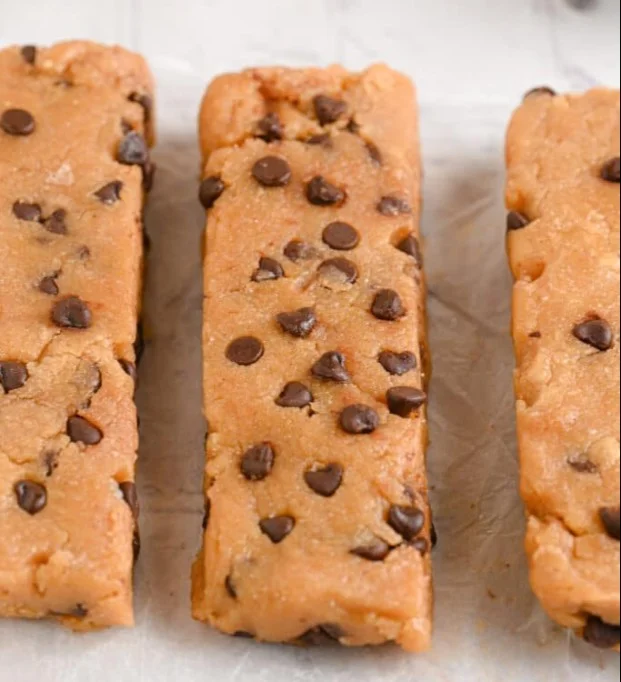 Homemade protein bars with nuts and chocolate on a wooden table