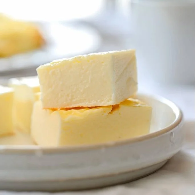 Plate of homemade protein cheese with herbs and spices on a wooden table