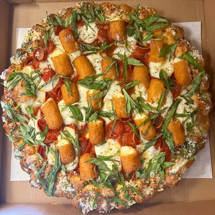 Hot Honey Roni Cups served with Mozza Stick Margherita Pizza on a wooden board.