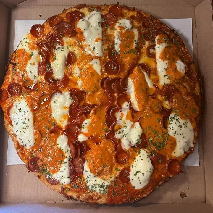 Sicilian pizza with hot honey roni cups, vodka sauce, and fresh mozzarella