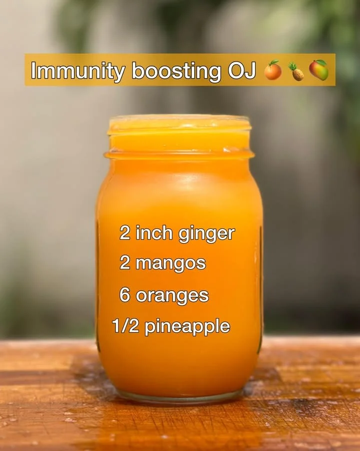 A glass of immunity-boosting orange juice with fresh oranges.
