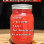 Glass of iron boosting fruit punch with colorful fruits