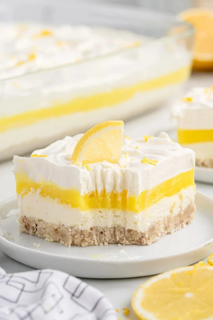 Delicious Lemon Lush dessert showcasing its vibrant yellow layers and whipped topping.