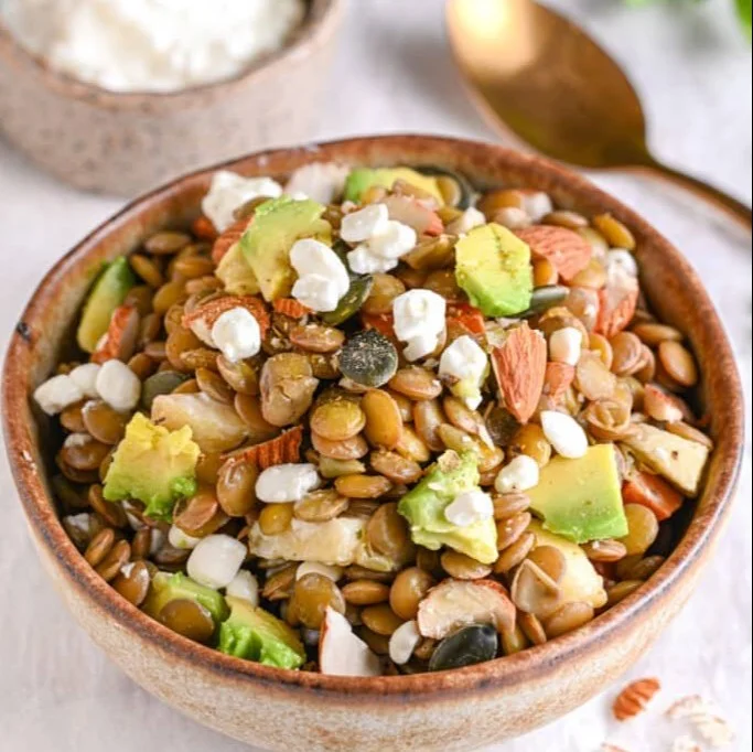 Fresh and colorful lentil salad topped with vegetables and herbs