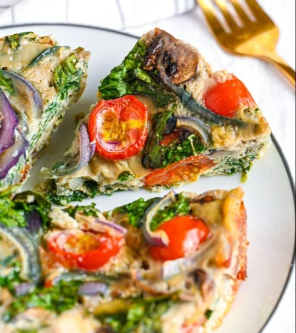 Light and fluffy egg white frittata with fresh vegetables served on a plate.