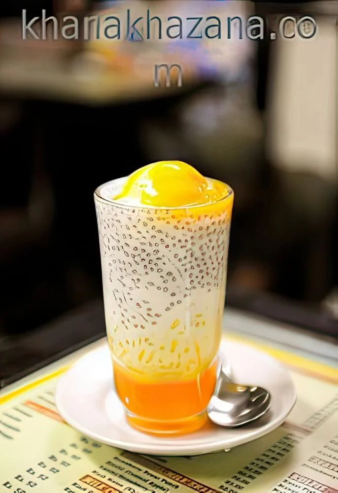 Delicious Mango Falooda dessert topped with basil seeds and mango slices