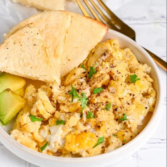 Bowl of microwave scrambled eggs cooked to fluffy perfection