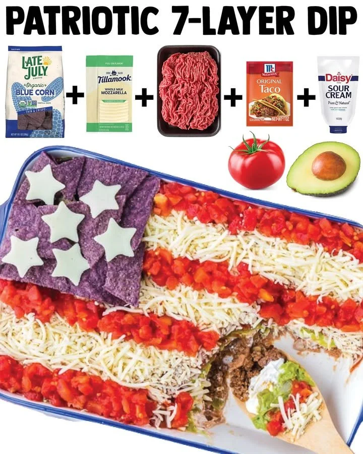 Delicious patriotic taco dip served in a bowl with toppings.
