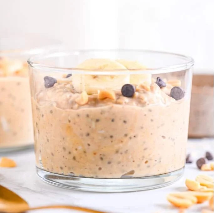 A bowl of PB2 overnight oats topped with banana and nuts, healthy breakfast option