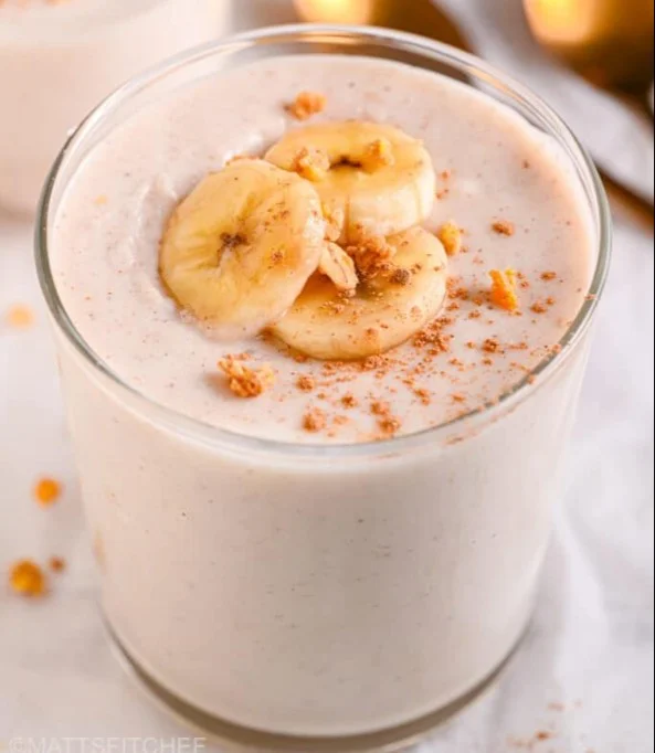 Delicious Peanut Butter Banana Smoothie in a glass with banana slices and peanut butter