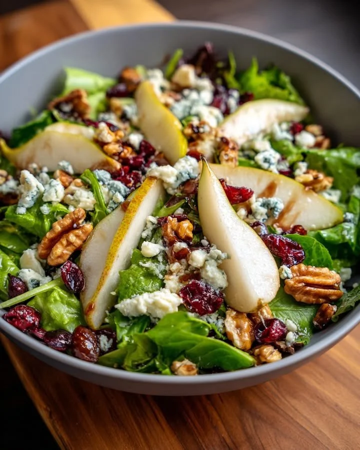Pear, Blue Cheese & Walnut mixed greens salad in a bowl