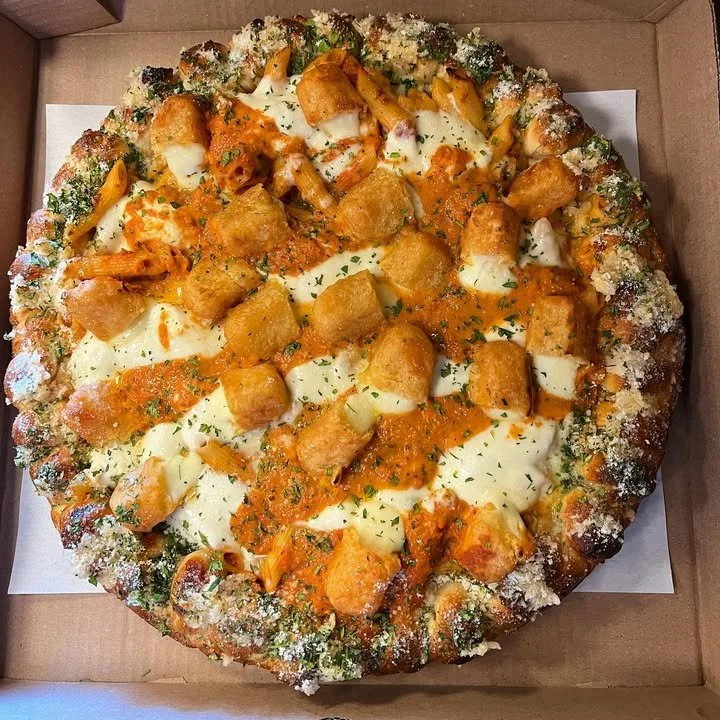 Penne Vodka Pizza topped with mozzarella sticks and creamy vodka sauce