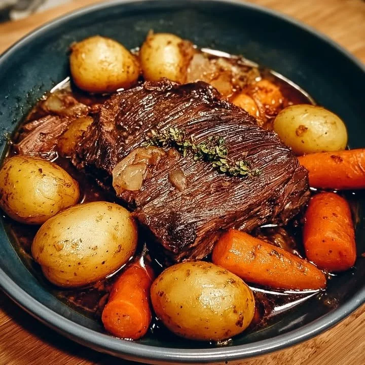Succulent pot roast with potatoes and carrots served on a plate