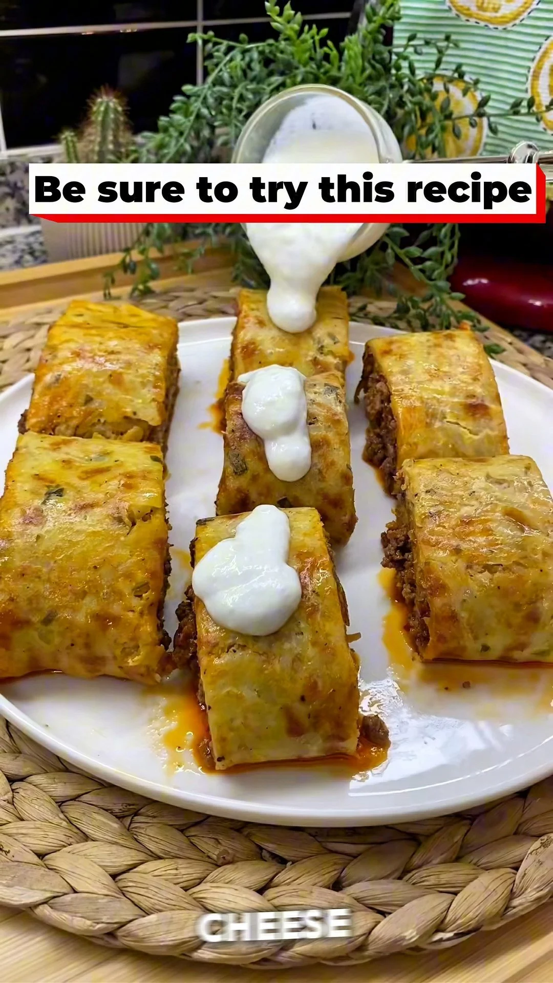 Freshly baked potato rolls filled with minced meat on a rustic wooden table.