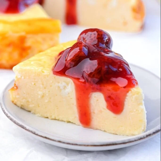 Delicious Protein Cheesecake topped with fresh berries and mint leaves