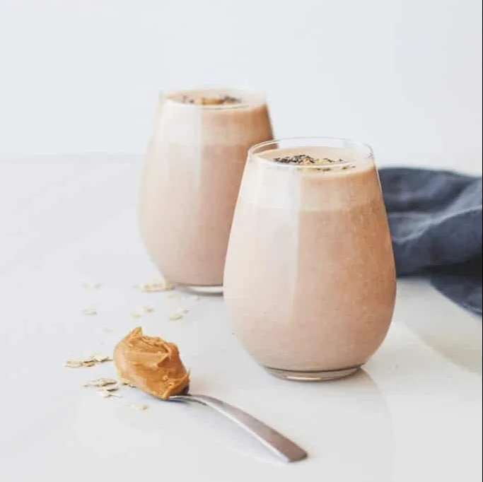 Delicious protein smoothie in a glass with fresh fruits and ingredients