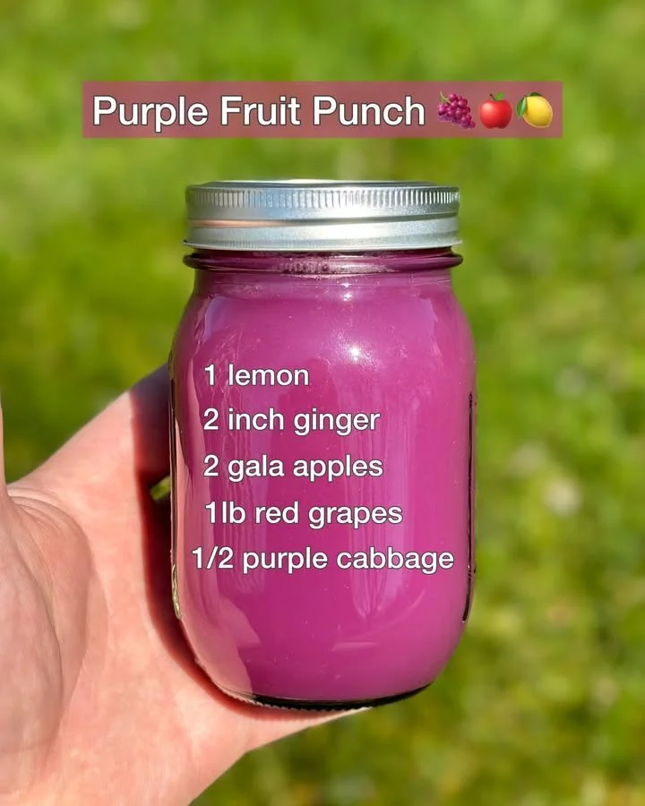 Vibrant Purple Fruit Punch in a glass with colorful fruit garnishes