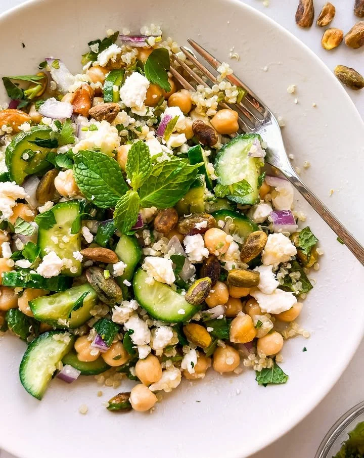 A vibrant Quinoa Chickpea Salad with fresh vegetables and herbs.