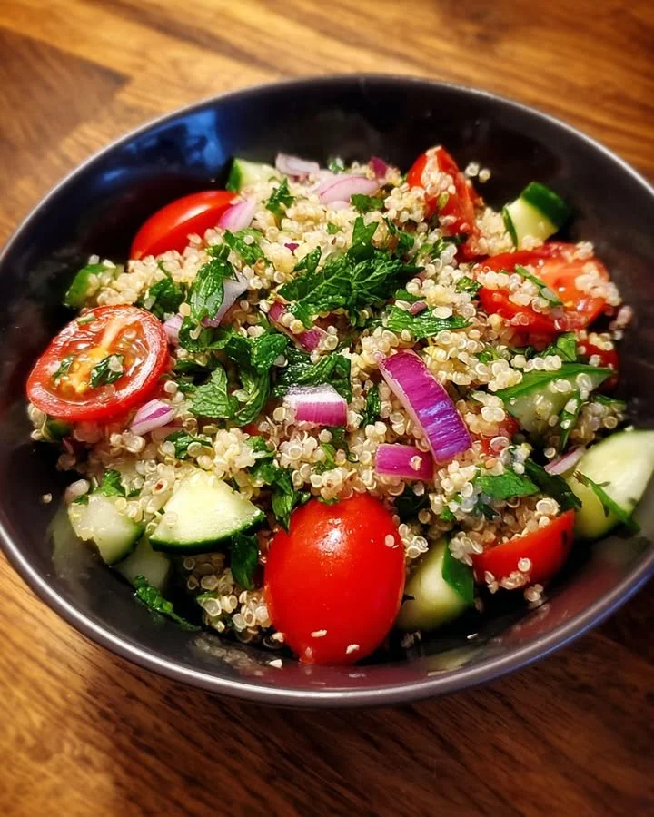 Bowl of quinoa tabbouleh salad with mint and lemon dressing