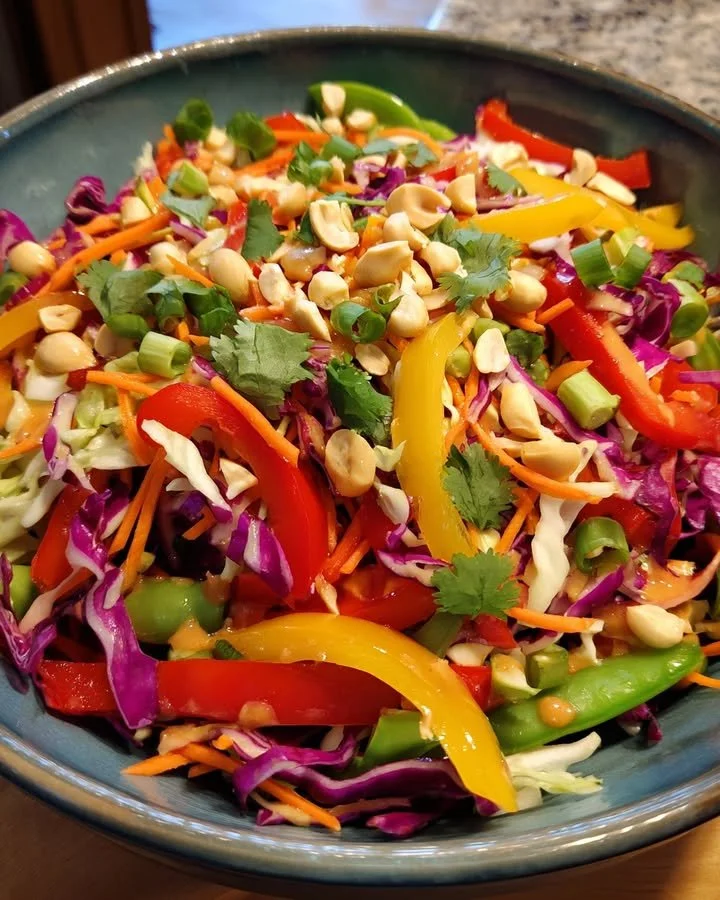 Colorful Rainbow Veggie Crunch Salad drizzled with creamy peanut dressing