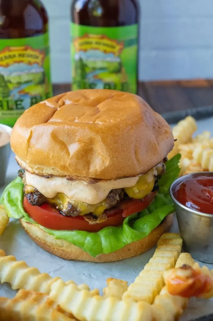 Ranch Burger topped with Chipotle Mayo on a rustic wooden plate.