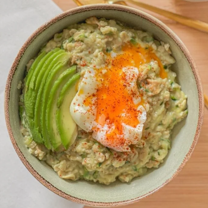 Savory oatmeal topped with avocado and a perfectly poached egg.