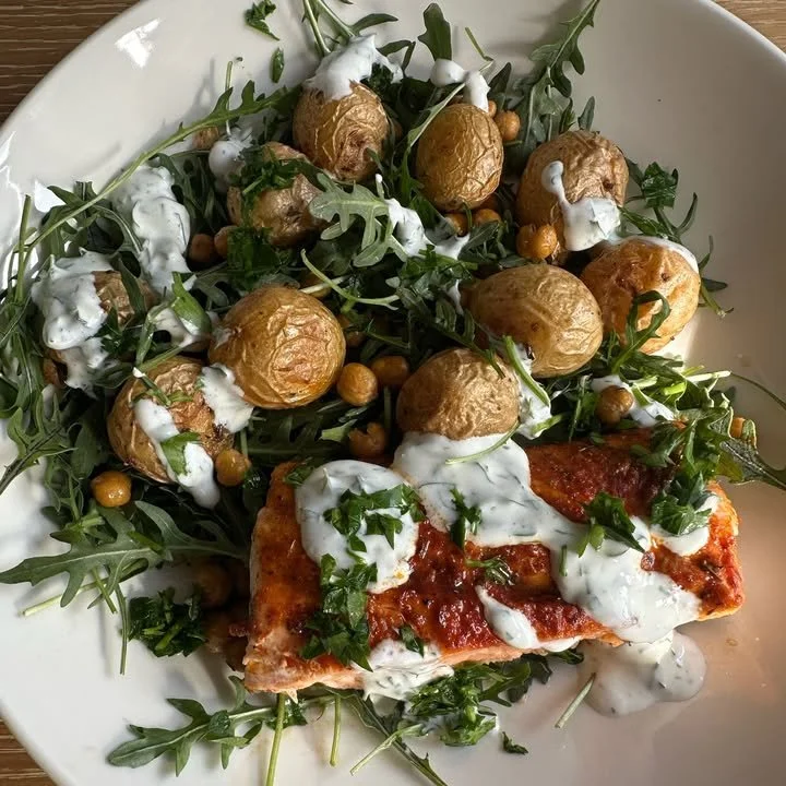 Sheet pan salmon dinner with chickpeas and potatoes on a rustic wooden table