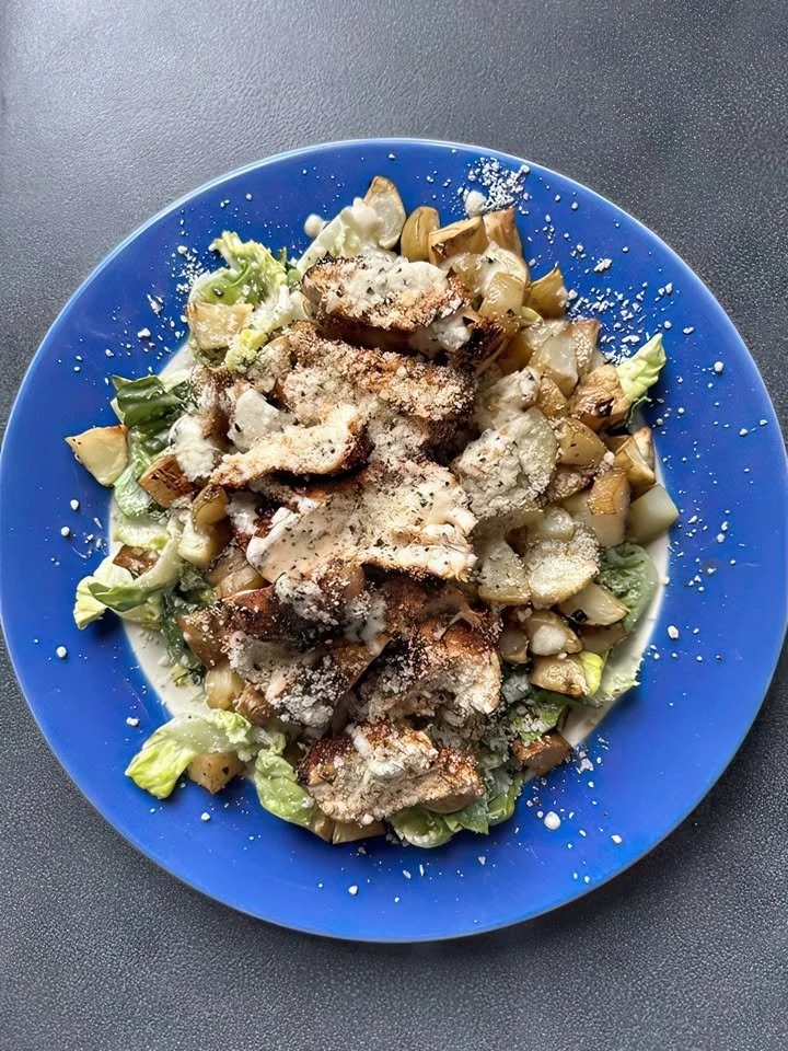 Creamy butter bean and herb stew served in a bowl, garnished with fresh herbs.