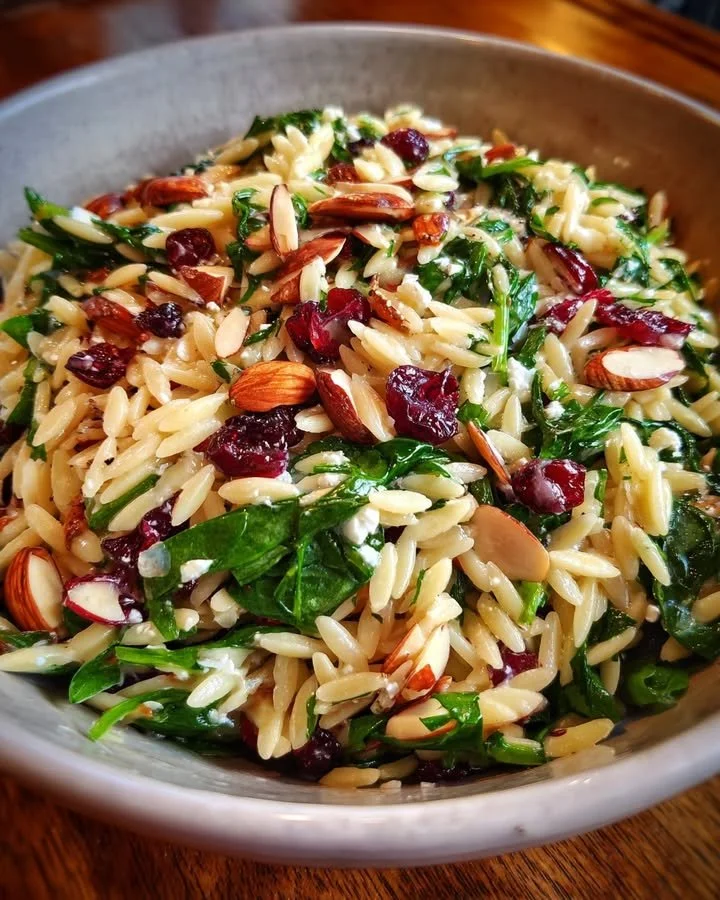 Fresh Spinach Orzo Salad with cranberries and almonds served in a bowl