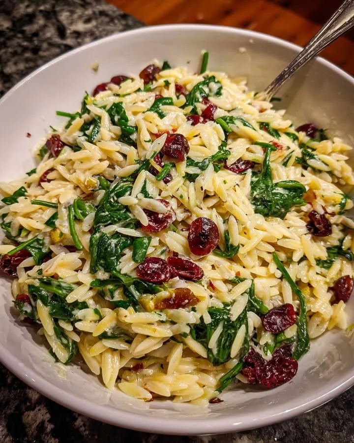 Spinach and Cranberry Orzo with Lemon Cream Sauce served in a bowl.