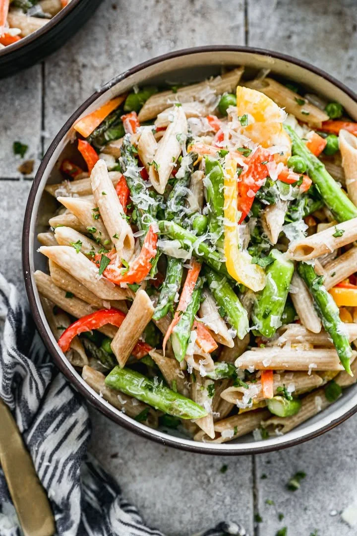A vibrant spring pasta dish with fresh vegetables and herbs