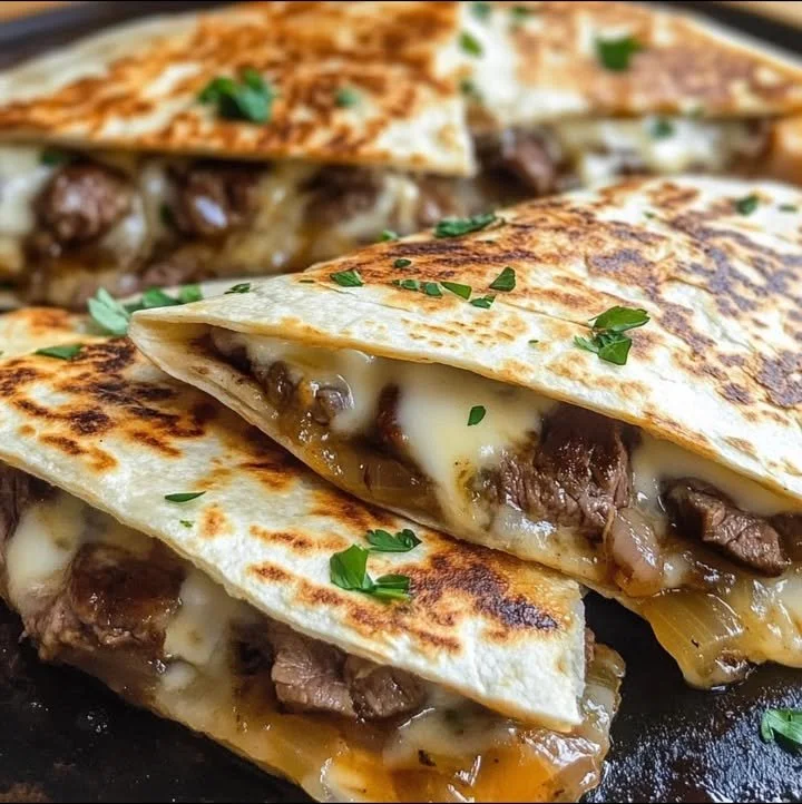 Delicious Steak Quesadillas filled with cheese on a plate