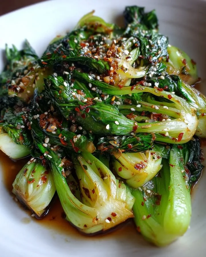 Stir-fried baby bok choy with soy garlic glaze served on a plate.