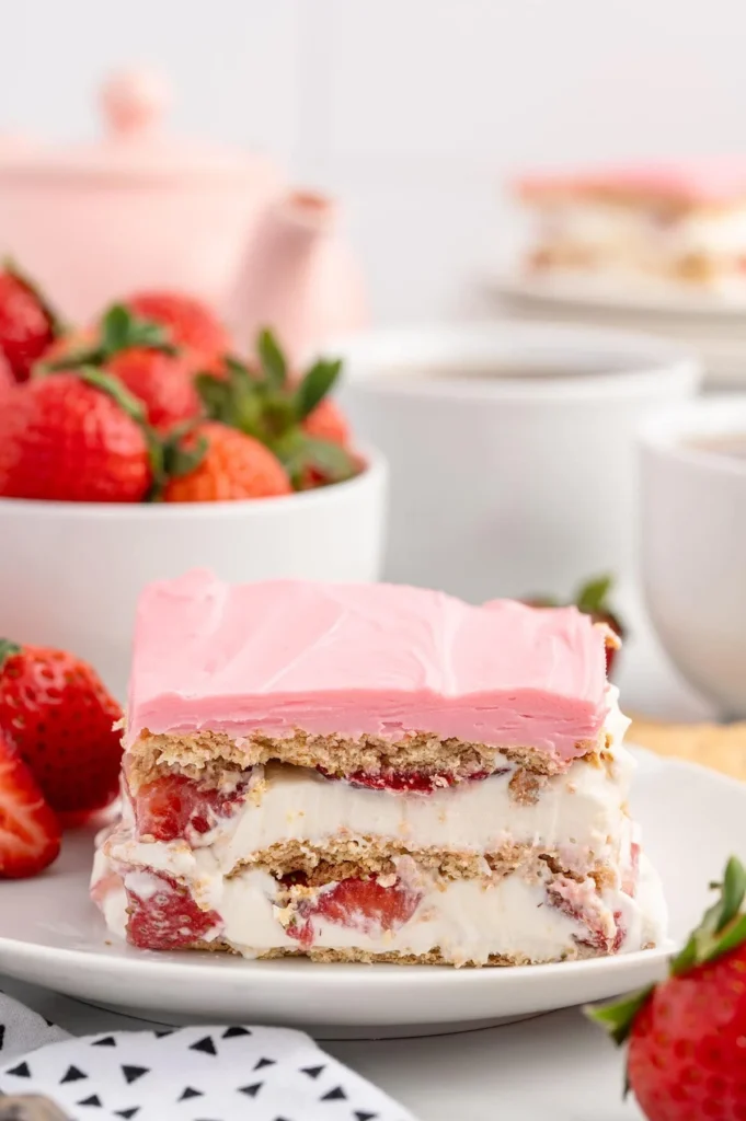 Strawberries and Cream Éclair Cake with fresh strawberries on top
