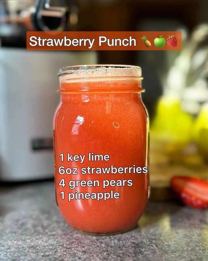 Refreshing strawberry punch served in a glass with fresh strawberries.